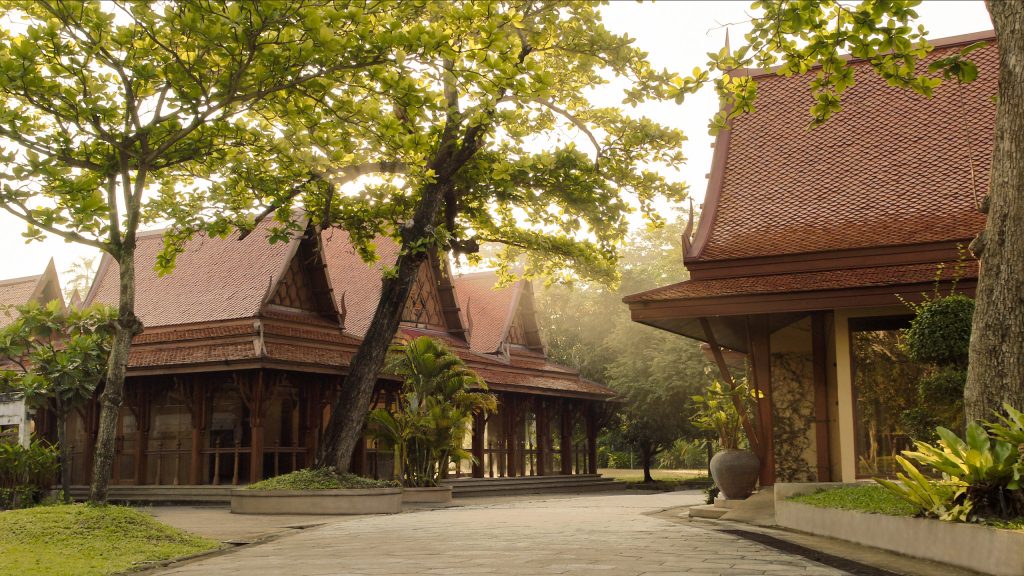 Traditional Thai architecture surrounded by lush greenery at RXV Wellness Village, reflecting serene design and natural harmony.