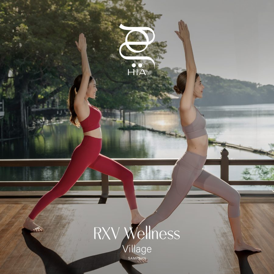 Two women practicing yoga by the riverside deck at RXV Wellness Village Sampran