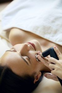 Close-up of a therapist performing a body contouring treatment using radiofrequency technology on a guest’s leg at RXV Wellness Village Sampran.