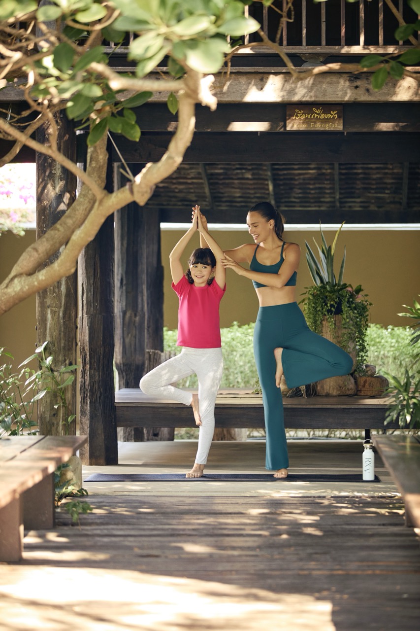 Mother and child practicing yoga together at RXV Wellness Village Sampran promoting family wellness and balance.