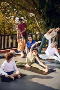 Outdoor yoga for all ages at RXV Wellness Village Sampran, guided by wellness instructors in a natural setting.