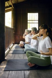 Mindful breathing practice session at RXV Wellness Village Sampran in a serene wooden pavilion.