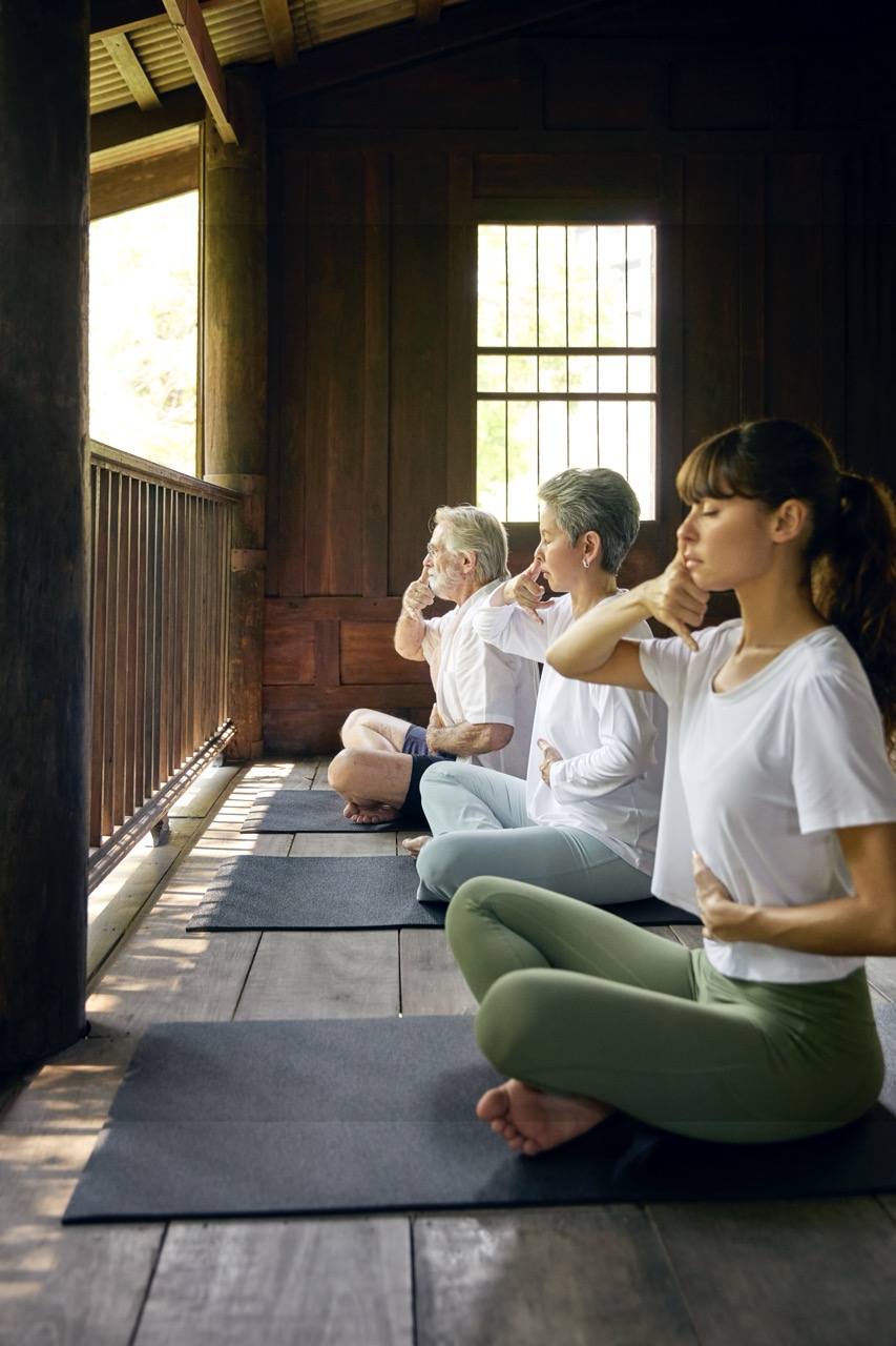 Mindful breathing practice session at RXV Wellness Village Sampran in a serene wooden pavilion.
