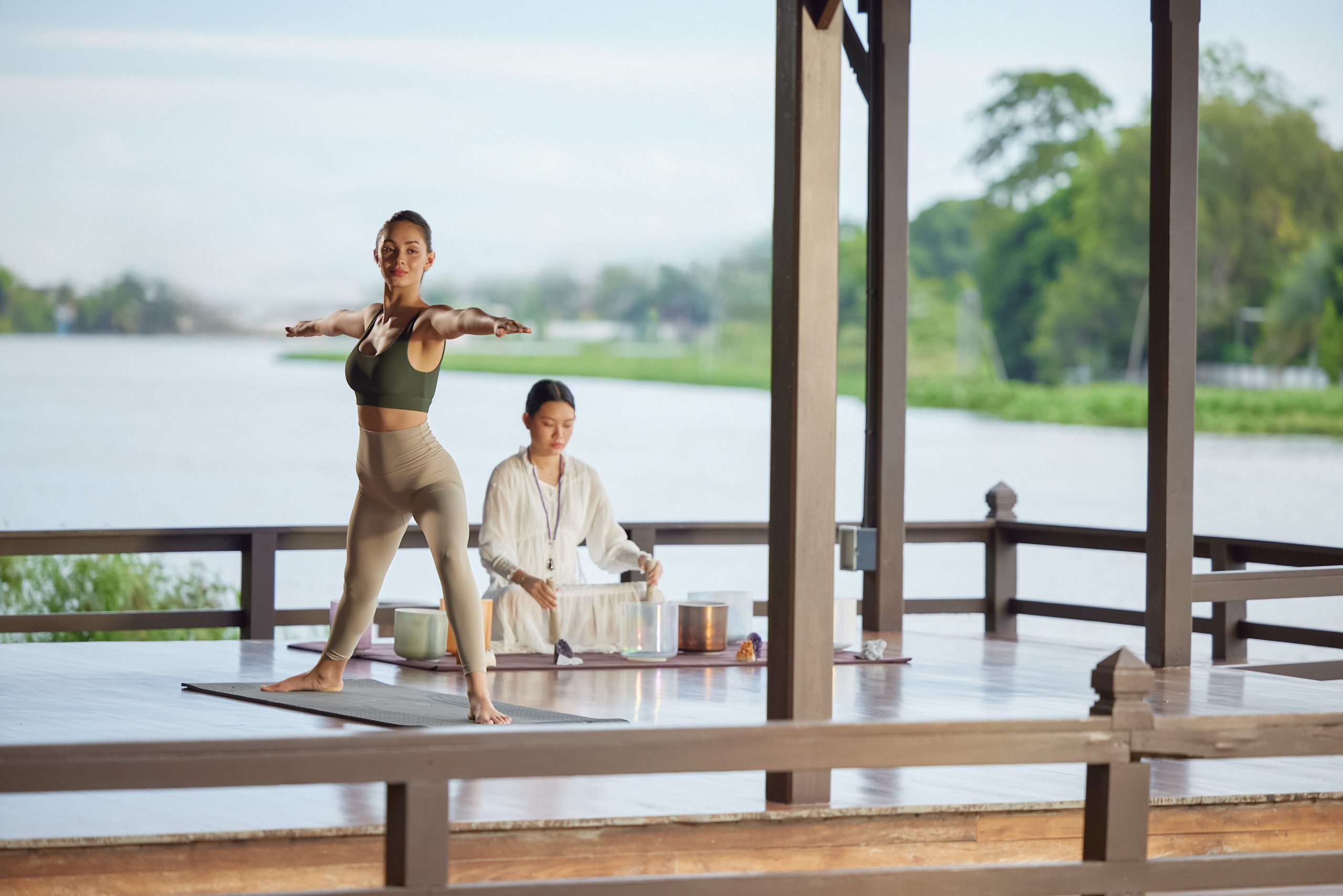 Yoga and sound healing session by the riverside at RXV Wellness Village Sampran.
