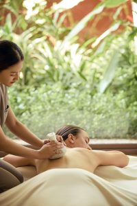 Back massage therapy session in a serene treatment room at RXV Wellness Village Sampran.