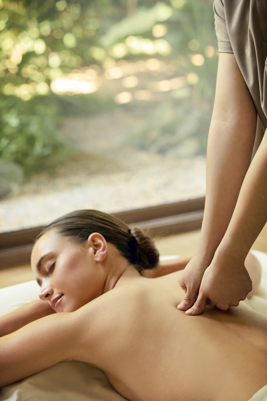 Back massage therapy session in a serene treatment room at RXV Wellness Village Sampran.