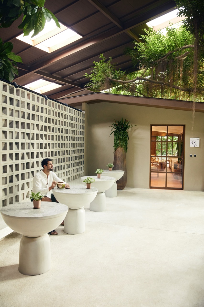 Man relaxing with a drink in the serene lounge area at RXV Wellness Village Sampran.