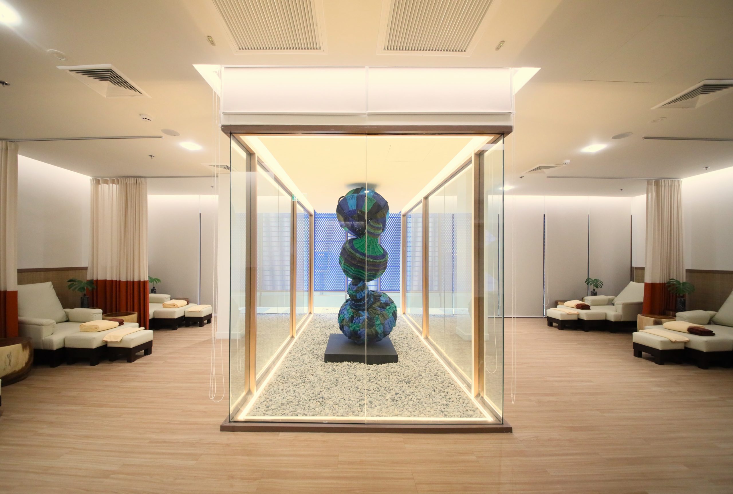 Modern relaxation lounge with art installation at RXV Wellness Village Sampran.