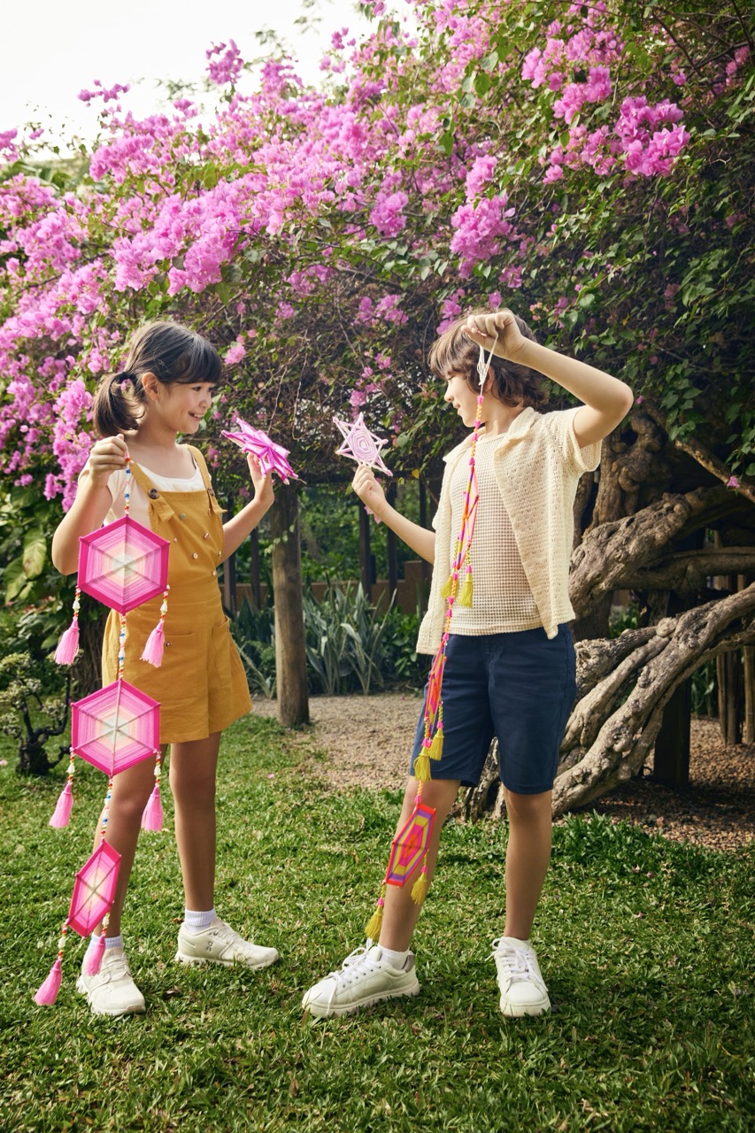 Children creating traditional lanterns in the garden at RXV Wellness Village Sampran.