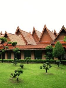 Traditional Thai-style roof architecture surrounded by manicured gardens at RXV Wellness Village Sampran.